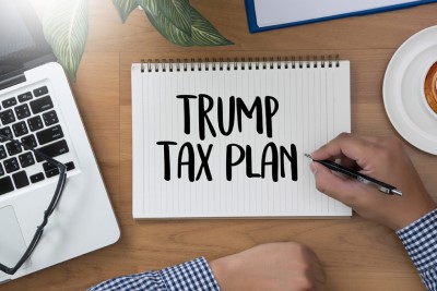 person writing trump tax plan on a notebook